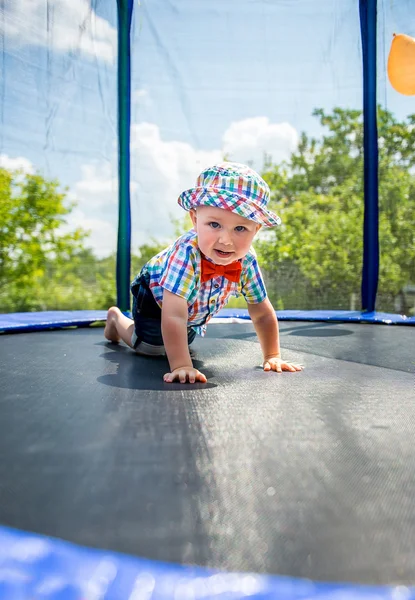 Kid jumping on a trampoline — Stock Photo, Image