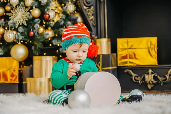 Cute Little Boy Dressed Elf Opens Christmas Present Decorated Christmas — Stock Photo, Image