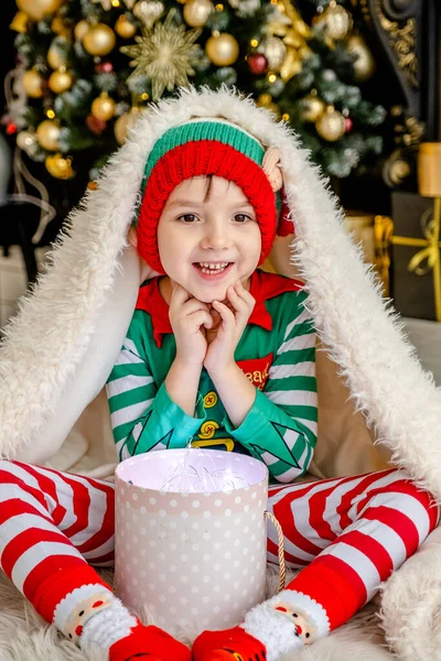 Cute Little Boy Dressed Elf Opens Christmas Present While Hiding — Stock Photo, Image