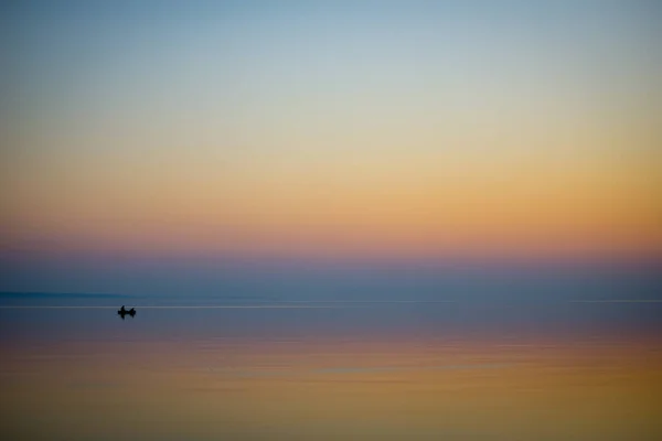Fishermen with boats catching fish in the sea at sunset in calm — Stock Image Fishermen Boats Catching Fish Sea Sunset Calm Stock Image