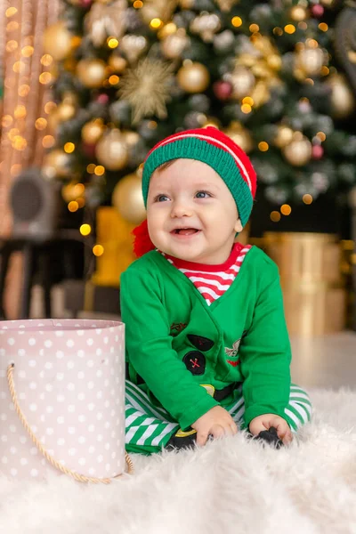 Cute Little Boy Dressed Elf Opens Christmas Present Decorated Christmas — Stock Photo, Image