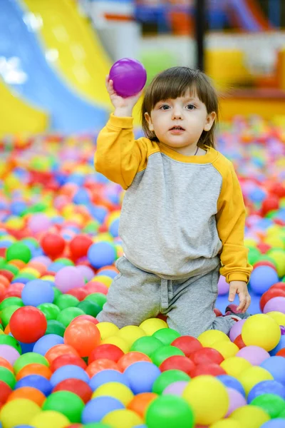 Creative development of children. The kid plays with colored balls in the childrens development center. — Stock Photo, Image