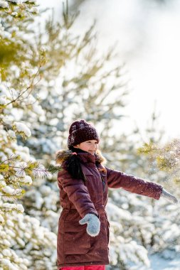 Bir çocukla ormanda aktif bir kış yürüyüşü. Aktif Noel tatili. Kışın karlı ormanda bir kızla yürümek. Mutlu çocukluk, sağlıklı yaşam tarzı.