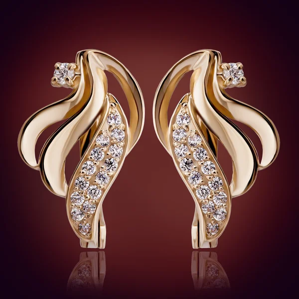 Gold earrings with diamonds — Stock Photo, Image