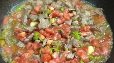 Cooking meat saute. Pieces of meat diced fried in a pan close-up video. Stewing beef and vegetables.