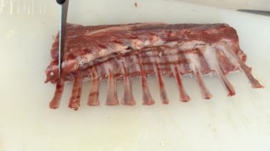Cutting of sheep meat. Butcher chopping or cutting fresh lamb meat.Preparation of lamb ribs. Video