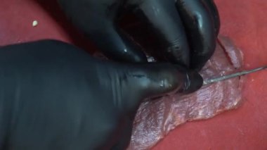 Kuba et dorama. Chopping meat with chef knife in kitchen. Video