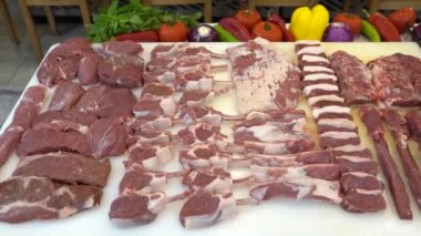 Different types of raw meat. Close up of sliced red meat with spices in a motion video. 