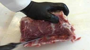 Cutting of sheep meat. Butcher chopping or cutting fresh lamb meat.Preparation of lamb ribs. Video 