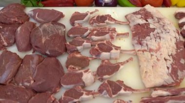 Different types of raw meat. Close up of sliced red meat with spices in a motion video. 