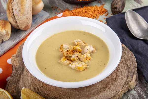 Lentil soup with kruton bread in a ceramic white bowl on a wooden background — Stock Image Lentil Soup Kruton Bread Ceramic White Bowl Wooden Background Stock Image