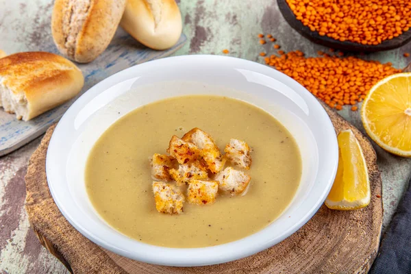 Lentil soup with kruton bread in a ceramic white bowl on a wooden background — Stock Image Lentil Soup Kruton Bread Ceramic White Bowl Wooden Background Royalty Free Stock Photos