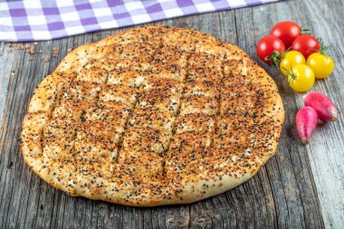 Ramadan Pita (Ramazan Pidesi) Traditional Turkish bread for holy month Ramadan. Fresh sliced pita bread . clipart