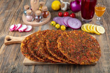 Geleneksel lezzetli Türk yemekleri; Lahmacun (Türk pizzası). Lahmacun geleneksel Türk pizzası ve kırsal ahşap masaya izole edilmiş salata paketleri..