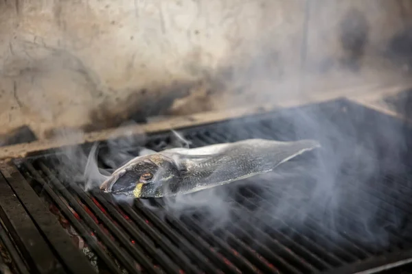 Sea bream fish on the grill. Grilled fish dish sea bream restaurant service