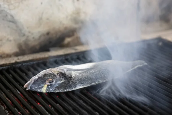 Sea bream fish on the grill. Grilled fish dish sea bream restaurant service