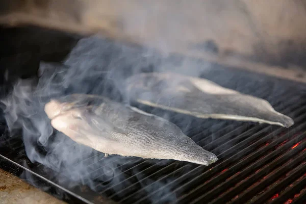 Sea bream fish on the grill. Grilled fish dish sea bream restaurant service