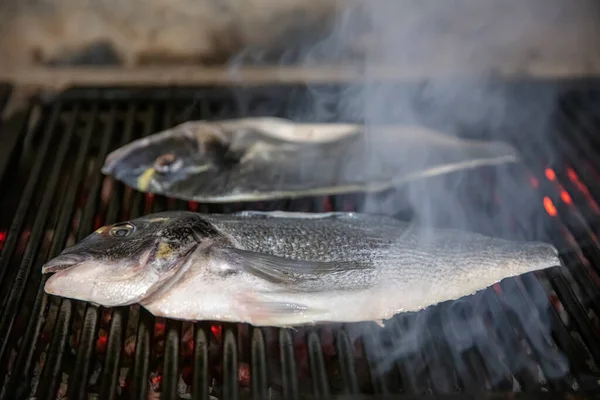 Sea bream fish on the grill. Grilled fish dish sea bream restaurant service