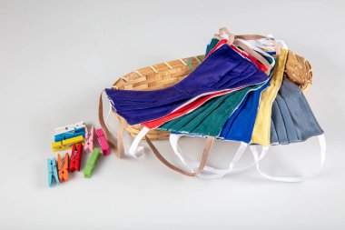 Üç tane elastik kulak halkalı yüz maskesi, üst üste yığılmış beyaz maske, arka planda mavi ve siyah. Coronavirus covid-19 salgını sırasında yeniden kullanılabilir pamuk kumaş maskeleri çok talep görüyor..