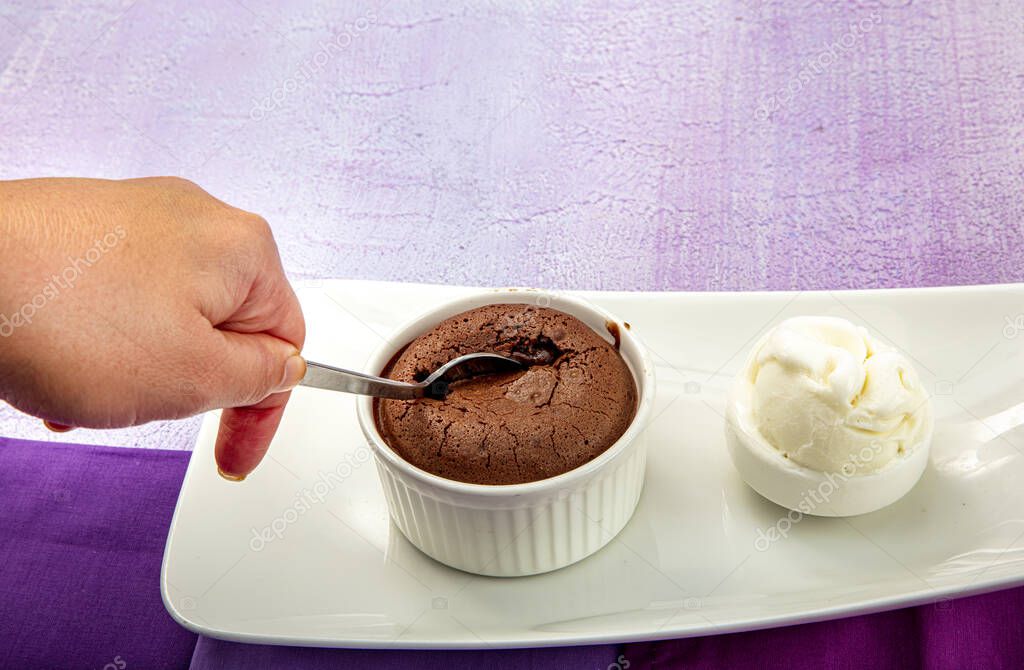 Delicious chocolate souffle with ice cream. Fluid chocolate souffle on white plate.