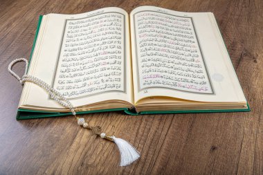 Istanbul, Turkey - April 5, 2015; A Quran book opened with a rosary. Quran - holy book of innocent Muslims (breadth of all Muslims).