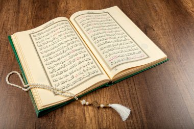Istanbul, Turkey - April 5, 2015; A Quran book opened with a rosary. Quran - holy book of innocent Muslims (breadth of all Muslims).