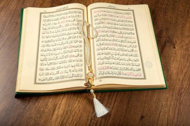 Istanbul, Turkey - April 5, 2015; A Quran book opened with a rosary. Quran - holy book of innocent Muslims (breadth of all Muslims).