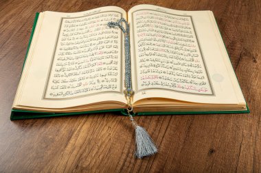 Istanbul, Turkey - April 5, 2015; A Quran book opened with a rosary. Quran - holy book of innocent Muslims (breadth of all Muslims).