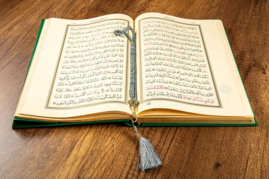 Istanbul, Turkey - April 5, 2015; A Quran book opened with a rosary. Quran - holy book of innocent Muslims (breadth of all Muslims).