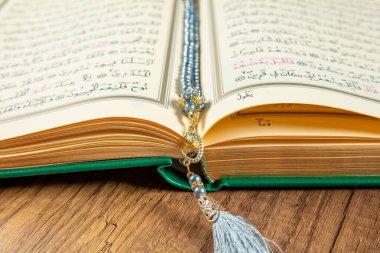 Istanbul, Turkey - April 5, 2015; A Quran book opened with a rosary. Quran - holy book of innocent Muslims (breadth of all Muslims).
