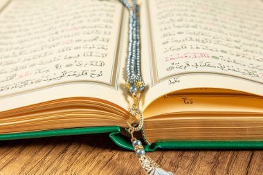 Istanbul, Turkey - April 5, 2015; A Quran book opened with a rosary. Quran - holy book of innocent Muslims (breadth of all Muslims).
