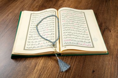 Istanbul, Turkey - April 5, 2015; A Quran book opened with a rosary. Quran - holy book of innocent Muslims (breadth of all Muslims).