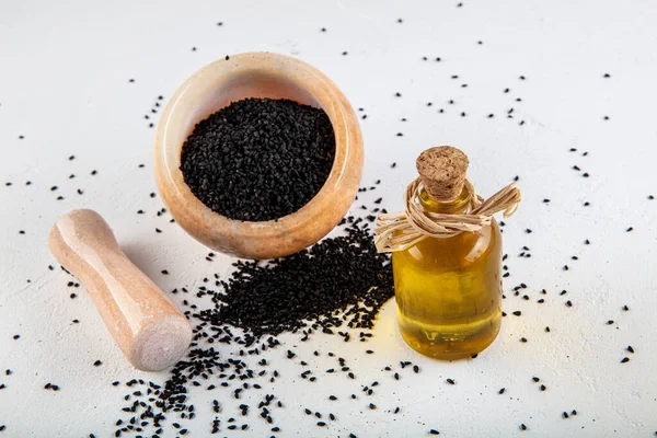 Black Cumin Seeds Bowl Essential Oil Glass Bottle Nigella Sativa — Stock Photo, Image