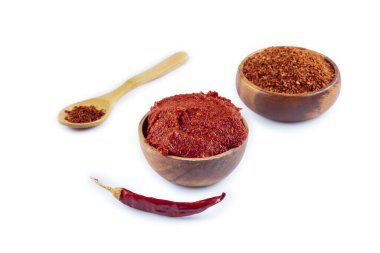 Turkish style pepper paste (biber salcasi). Wooden bowl with red sauce and fresh chili peppers isolated on white. clipart