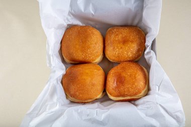 Taze pişmiş ve pudra şekerli Alman çörekleriyle süslenmiş - Berliner ya da Krapfen - beyaz masada..