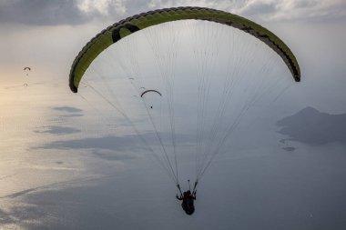 FethiyeOludeniz Babada dünyanın en önemli yamaç paraşütü bölgelerinden biri olarak kabul edilir. Mula, Türkiye. Cesur paraşütçüler Oludeniz tatil köyü yakınlarındaki Babadag dağından havalandılar.. 