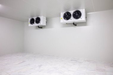 Warehouse freezer, Cold storage. Refrigeration chamber for food storage. an empty industrial room refrigerator with four fans. clipart