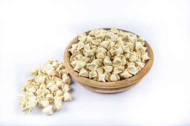 Ev yapımı Türk mantisi. (Türk mantısı) Pişmemiş. Pişirmeye hazır. Beyaz arka planda, pişirmeden önce el yapımı manti (Türkçe ravioli tipi hamur tatlısı).