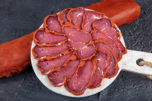 Turkish bacon, pastrami ( kayseri pastirma ) Fresh sliced pastrami. Pastrami ( dried meat with spices ). beef bacon sliced. traditional turkish food pastirma.