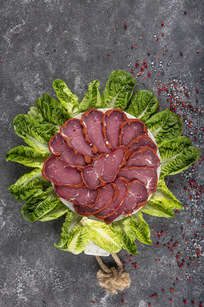 Turkish bacon, pastrami ( kayseri pastirma ) Fresh sliced pastrami. Pastrami ( dried meat with spices ). beef bacon sliced. traditional turkish food pastirma.