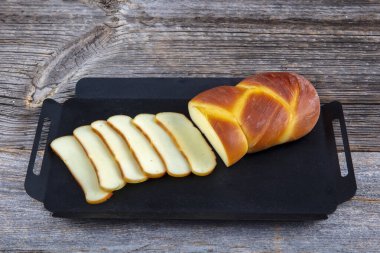 Tütsülenmiş peynir. Koyu ahşap masada füme peynir ve peynir..