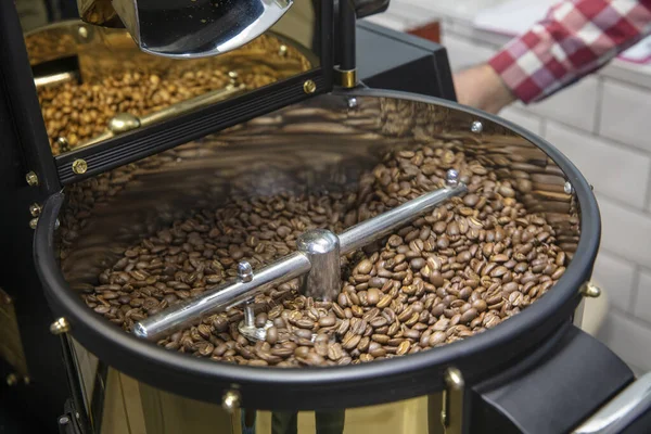Coffee Roaster. Roasting coffee beans hand close up