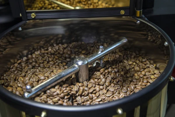 Coffee Roaster. Roasting coffee beans hand close up
