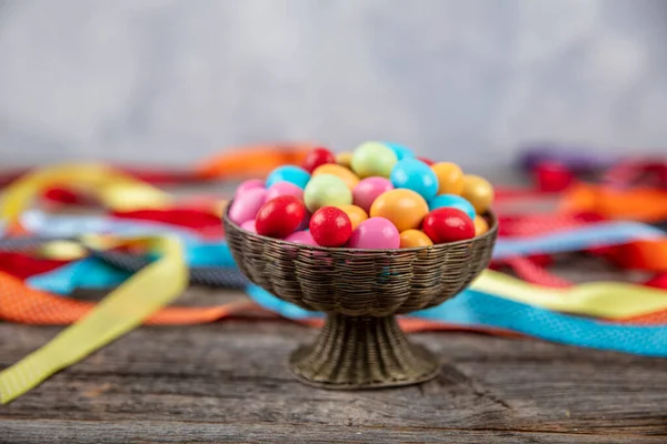 Colorful almond candy. Small colorful egg shape candies with almond inside. Sugared Almonds on wood background.Eid al-Fitr (Feast of Ramadan) concept.