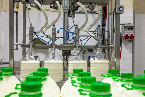 filling milk in to plastic bottles at the factory. equipment at the dairy plant