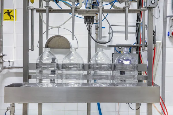 filling milk in to plastic bottles at the factory. equipment at the dairy plant