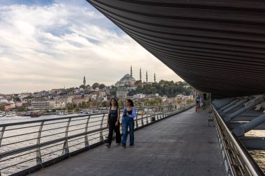 İstanbul Türkiye 24 Eylül 2024, Tramvay ve Golden Horn Metro Köprüsü 'ndeki insanlar. En kalabalıklardan biri olan Halic Tren İstasyonu 'nun manzarası Altın Boynuz' un üzerinde köprü istasyonu olarak yer almaktadır.. 