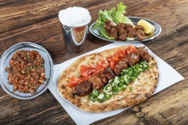 Geleneksel Türk mutfağı, lezzetli et sebzeli şiş kebap ve ahşap masada lavaş..