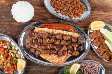 Turkish cuisine Liver shish portion. Famous Urfa meat liver, ciger wrapped by lavash with roasted chili pepper, onion and sauce in Sanliurfa, Turkey. Kuzu et ciger sis.