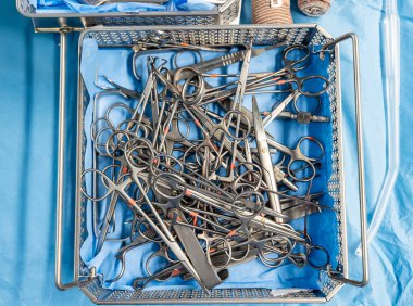  Hastane değerlendirmesi, sağlık hizmetleri veya tıbbi tiyatroda acil servis için ameliyathanede geçmiş, ameliyat ve metal aletler. Ameliyat için forseps ve makasla cerrahi ekipman.